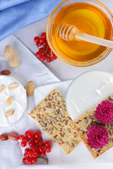 Cheese on white background, camembert, a glass of milk, Christmas cheese with honey, white background, blue napkin, pop art, red berries, Mexican cuisine, Indian cuisine, French breakfast