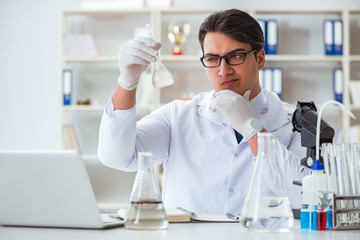 Young researcher scientist doing a water test contamination expe