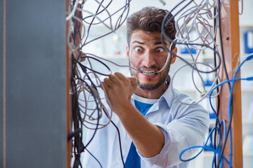 Computer repairman working on repairing network in IT workshop