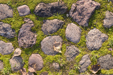 Fragment of the old road paved granite stones