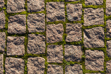 Fragment of the old road paved granite stones