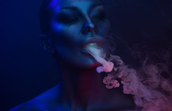 Vape Party, Nightlife. Beautiful Sexy Woman smoking