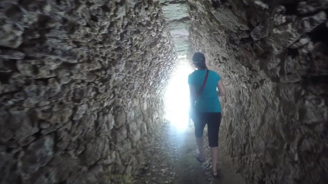 A woman in ancient Mayan tunnel at Coba