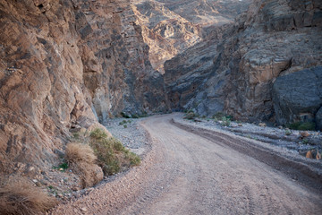 Dirt road through rocky canyon, Death Valley, USA