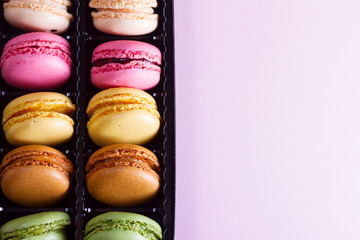 Close up background pile on fresh macaroons cookies, copy space on pink background