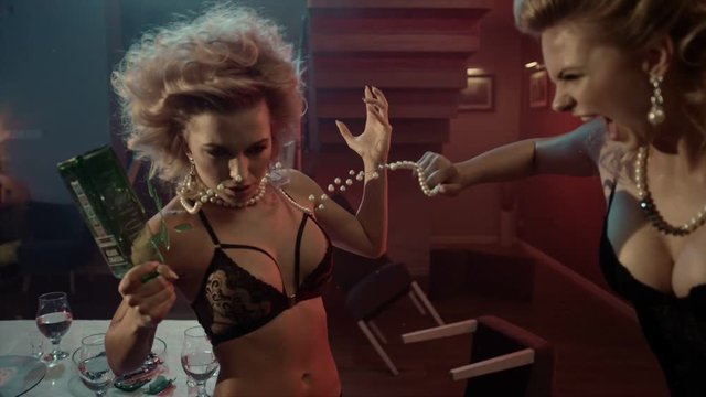 Food battle of sensual women. Stylish interior. Time freeze