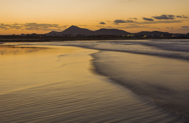 Caleta de Famara (Famara beach) шin Lanzarote island. Atlantic ocean. Beach view on Lanzarote Canary island in Spain