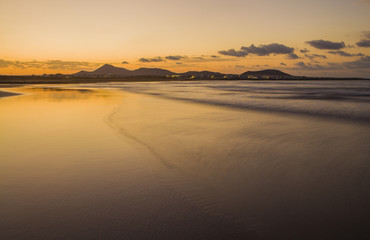 Caleta de Famara (Famara beach) шin Lanzarote island. Atlantic ocean. Beach view on Lanzarote Canary island in Spain