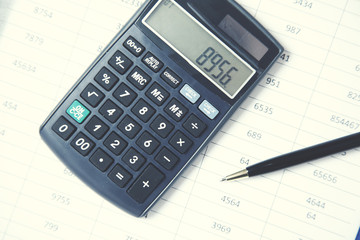 calculator and pen on document