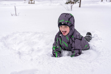 Little boy having fun in the snow