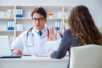 Obraz premium Young doctor in medical insurance fraud concept