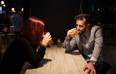 Couple in a pub, drinking beer
