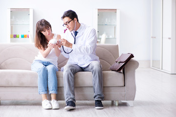 Woman with pet rabbit visiting vet doctor