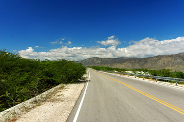 asphalt road and blue sky with white clouds