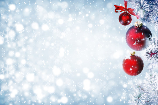 Christmas background with red ornaments and falling snow 
