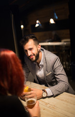 Man in a pub in front of girl, watching over