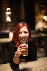 Girl in a pub holding craft beer