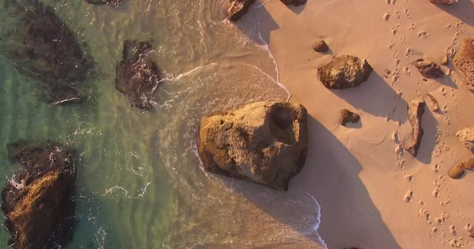 Birds eye view on the beach with waves crashing