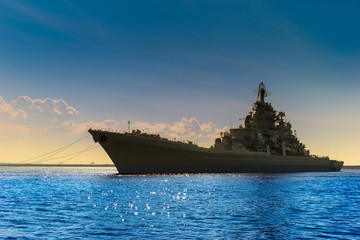 A large warship. Rocket cruiser. A military ship against the blue sky.