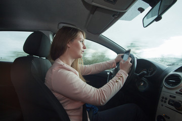 Woman using cellphone while driving