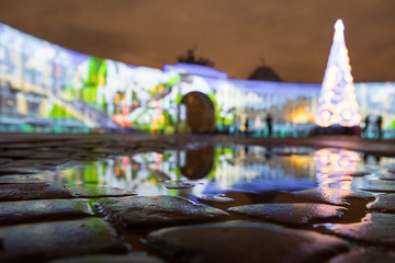 the main headquarters of the Palace Square in reflection /Christmas tree on the Palace Square on the background