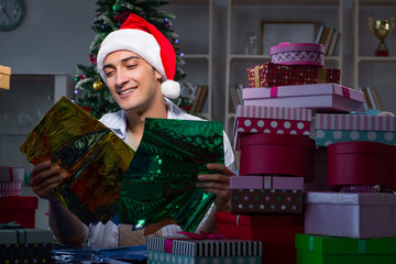 Man with many christmas gifts in boxes