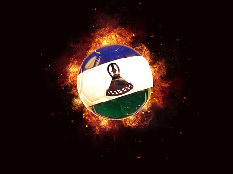 Football in flames with flag of lesotho