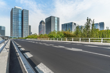 Fototapeta na wymiar road through the bridge with city skyline background.