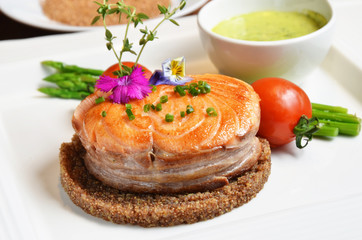 Deep fried salmon with red quinoa grains on the white plate