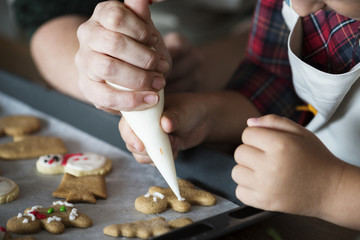 Boy making gingerbread cookies with his mum - obrazy, fototapety, plakaty