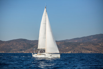 Fototapeta na wymiar Sailing yacht in the Aegean Sea near the Greek coast.