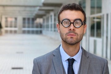 Fototapeta premium Foolish geek looking stunned in the office