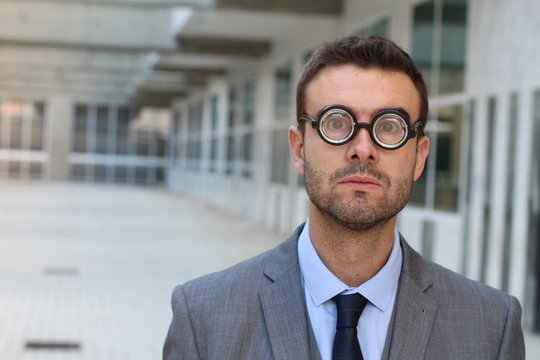 Businessman wearing thick glasses isolated  