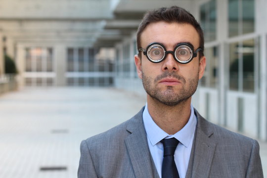 Clever male with very thick eyeglasses