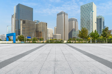 empty pavement and modern buildings in city.
