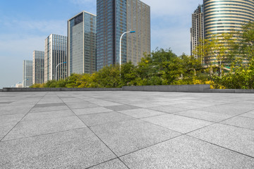 empty pavement and modern buildings in city.