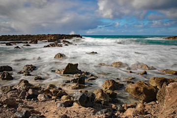 Fototapeta na wymiar Long exposure of ocean waves flowing over rocks at Sharks Cove, Oahu, Hawaii