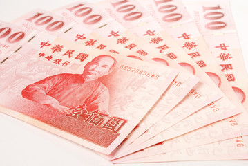 A lot of 100 New Taiwan Dollar bill on white background 