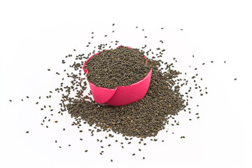 Sweet Basil seeds ,Ocimum canum Sims in pink paper cup on white background