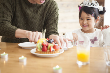 Dad and mommy are celebrating her daughter 's birthday.