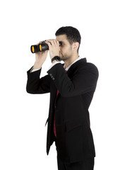 Young businessman using a binocular on studio
