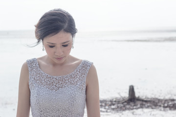 Beautiful asian bride at the beach