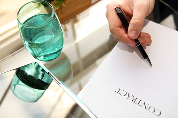Businessman is signing a contract, business contract details