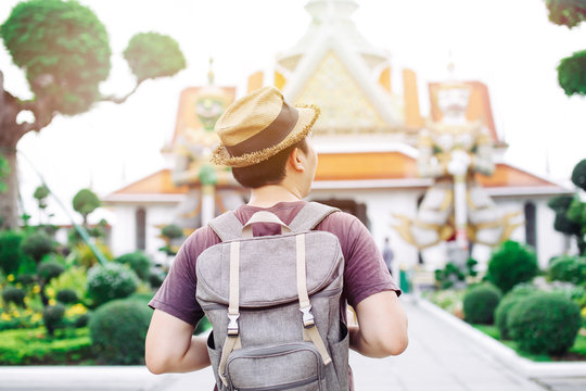 Young Asian traveling backpacker in Wat Arun in Bangkok, Thailand