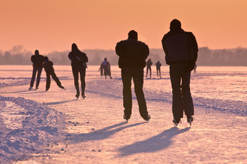 Ice Skaters under setting sun