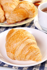  Delicious croissants on white plate  