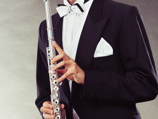 Elegantly dressed musician holding flute