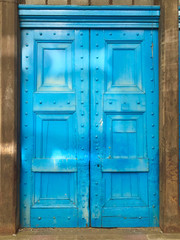 Obraz na płótnie Canvas 12 Foot Antique Blue Wooden Riveted Door 