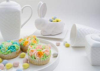Top view decorated cupcakes with Easter eggs on white Background.
