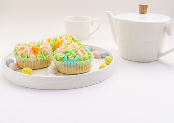 Top view decorated cupcakes with Easter eggs on white Background.